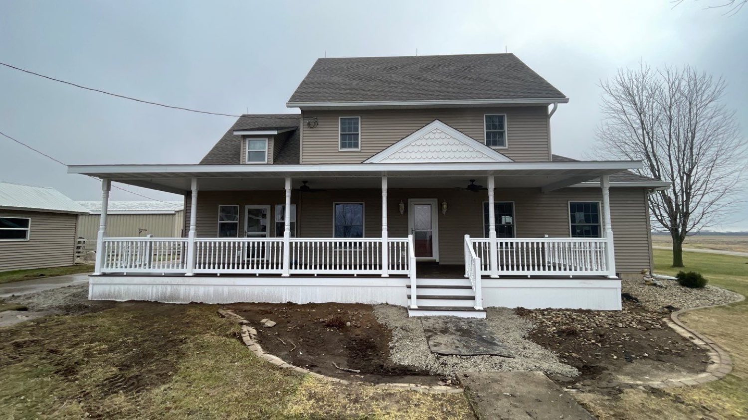 Farmhouse with a new covered wraparound porch